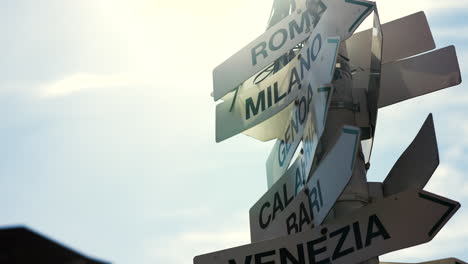 slow motion tilting shot showing the directions to multiple famous cities in italy