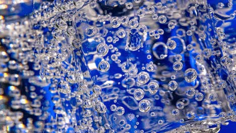 glass of water with ice on a dark blue background