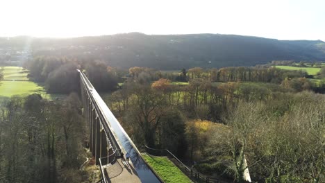 old welsh pontcysyllte aqueduct waterway aerial view rural autumn woodlands valley rising tilt down