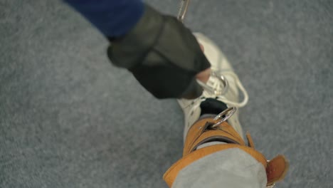 man sets the straps for the exercise classes are held in the sports hall for people with disabilities