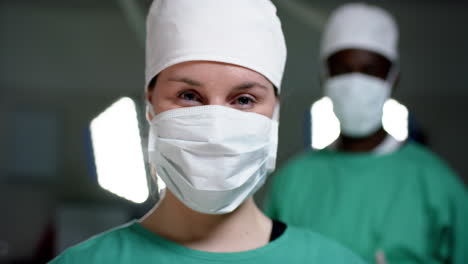 Portrait-of-diverse-surgeons-wearing-surgical-gowns-in-operating-theatre,-slow-motion