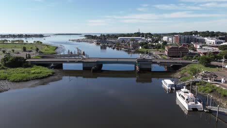 an aerial timelapse over the norwalk river railroad bridge on a sunny day