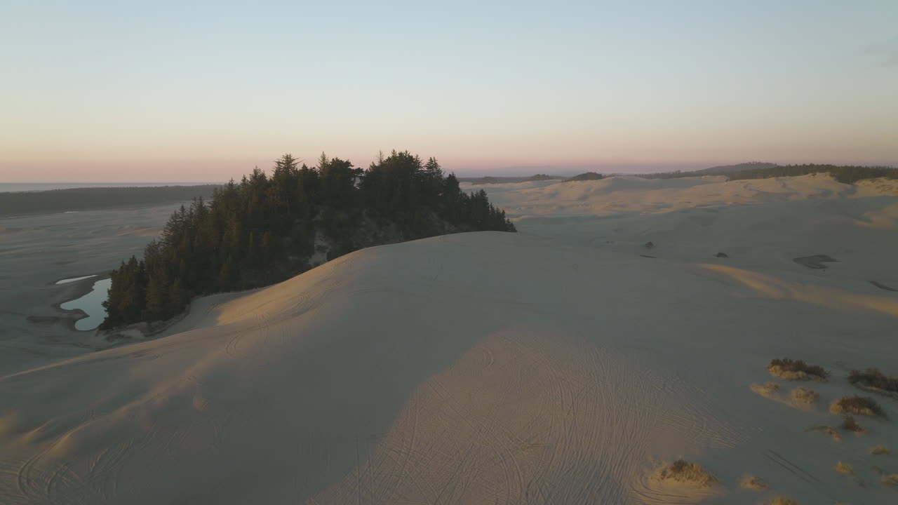 Flyover above sand dunes near Dunes City, Oregon on coast, inspiration for desert planet Arrakis in Dune movie franchise.