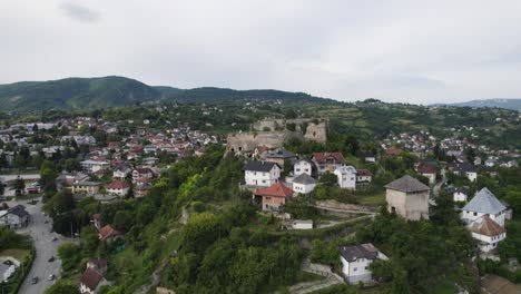 jajce citadel aerial view orbiting walled city stronghold with mount orjen mountain landscape, bosnia