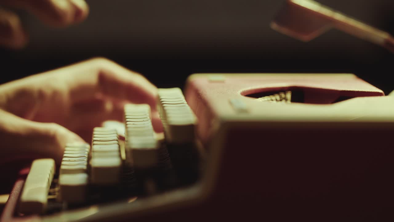 Hands of Writer Working on Vintage Typewriter at Desk