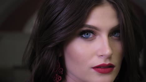 close-up portrait of a beautiful woman with red lips and blue eyes