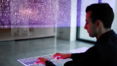 man interacting with futuristic holographic keyboard and data display