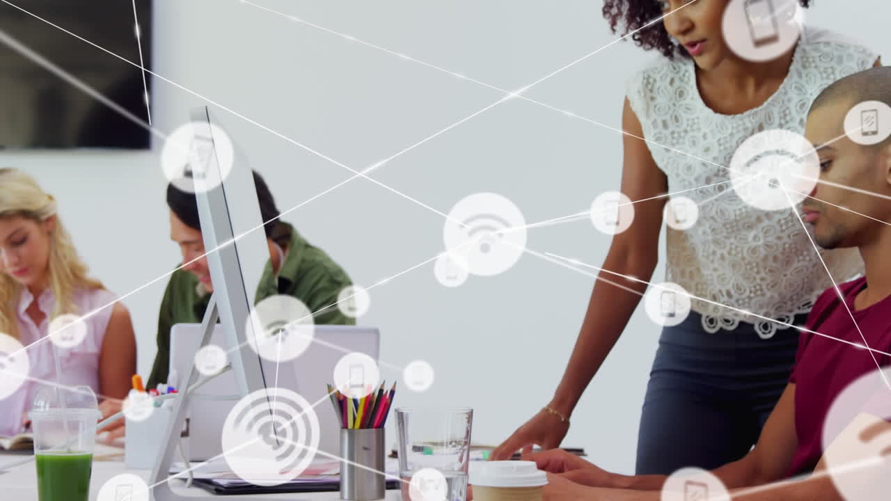 Animation of network of connections with icons over diverse business people in office