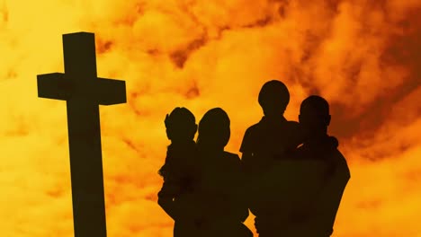 animation of silhouette of christian cross and family with two children over cloud