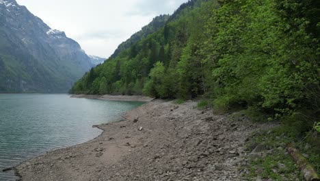 Drone-view-over-the-shores-of-Klöntalersee-Glarus-Kanton-lake,-Switzerland