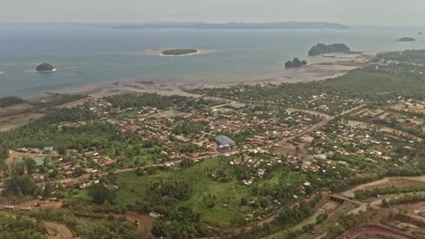 A-vast-aerial-drone-shot-of-Taganito-Nickel-Mines,-the-surrounding-area-and-coastline-in-Philippines