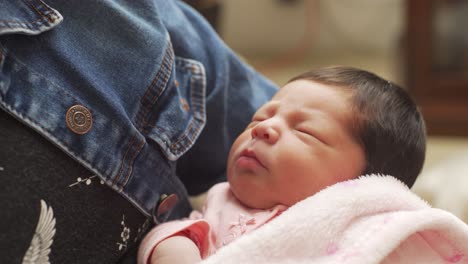 static-shot-of-a-mother-holding-her-newborn-baby-girl