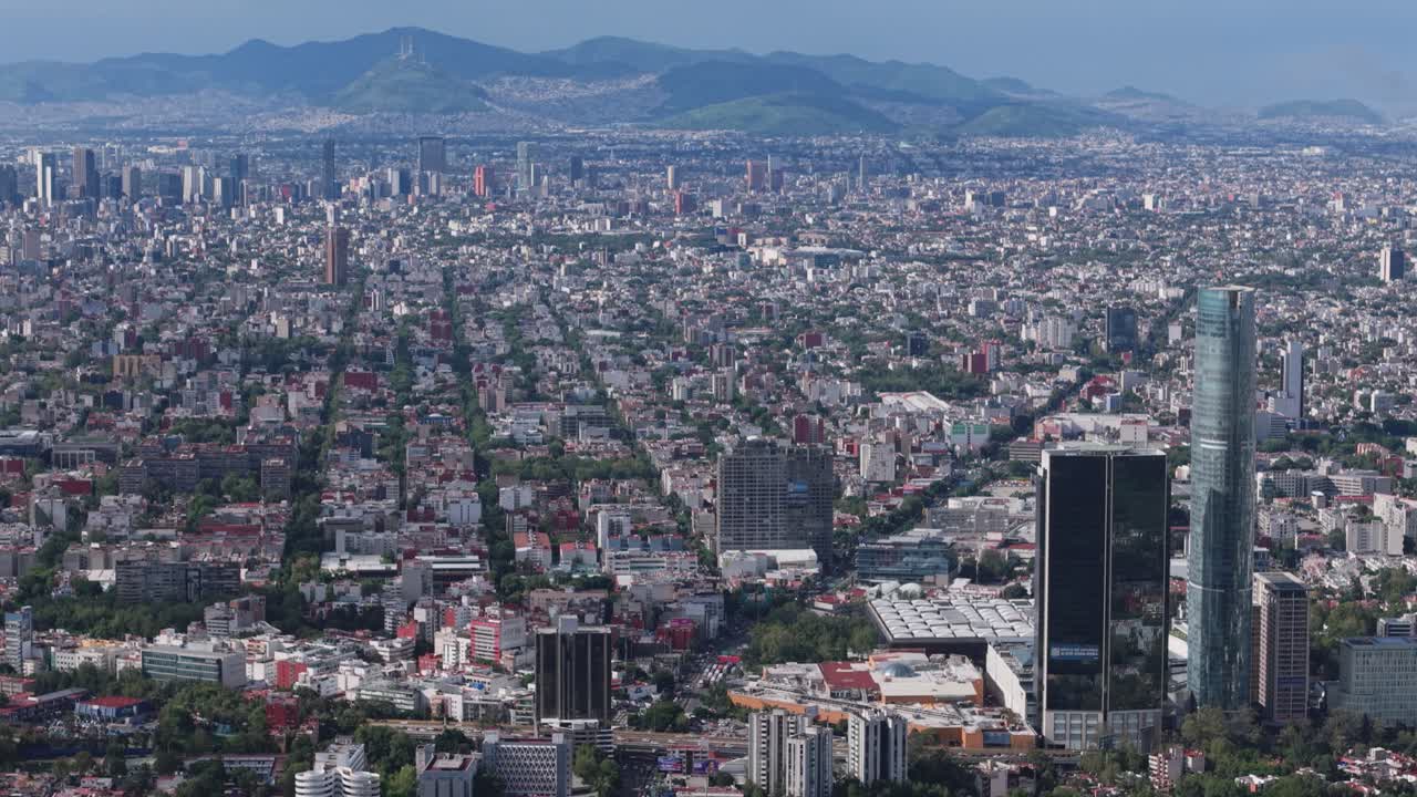Aerial drone footage of Mexico City on a clear and detailed afternoon