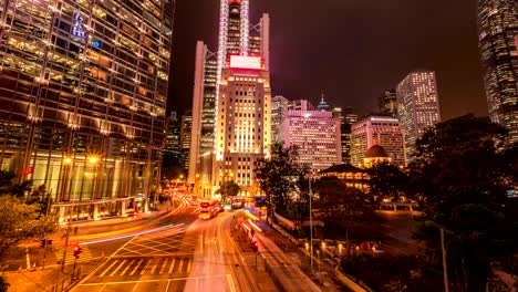 timelapse of traffic and building in hong kong. car and bus running on the road. people moving on pedestrian crosswalk on rush hour in the big city.