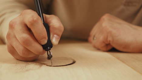 Close-up-timelapse-footage-of-artist-woodburning