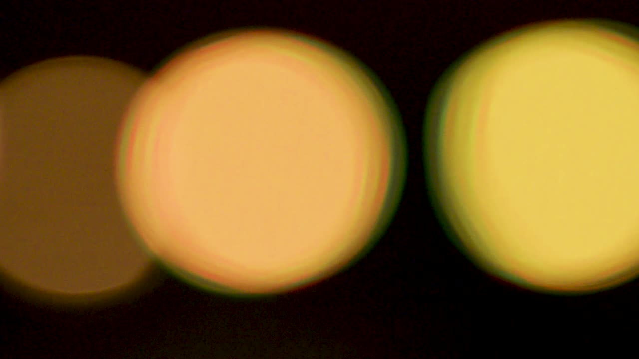 Yellow blurring lights abstract circular bokeh on black background video