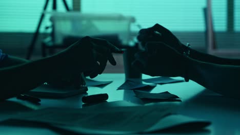close up detail video of the hands of a suspect offender perpetrator or prisoner and a detective close up detail video of the hands of a suspect offender perpetrator or prisoner and a detective policeman sitting in the interrogation room discussing the case true crime documentary creative