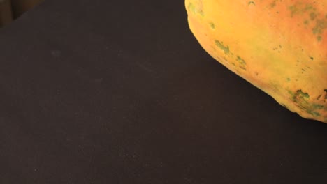 papaya slice and papaya juice on green leaf and black background, healthy and diet fruit