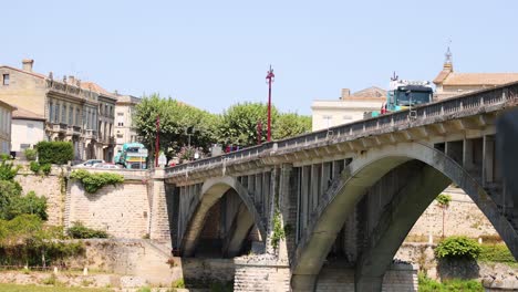 vehicles and birds on a historic bridge