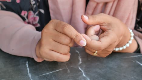 closeup of a woman's hands with a ring and bracelet