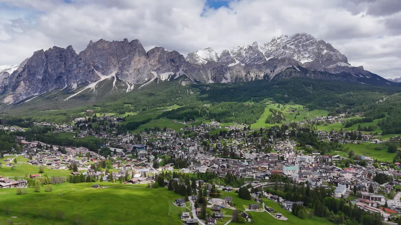 Drone view of Cortina d'Ampezzo with Tofane peaks and green Ampezzo Valley