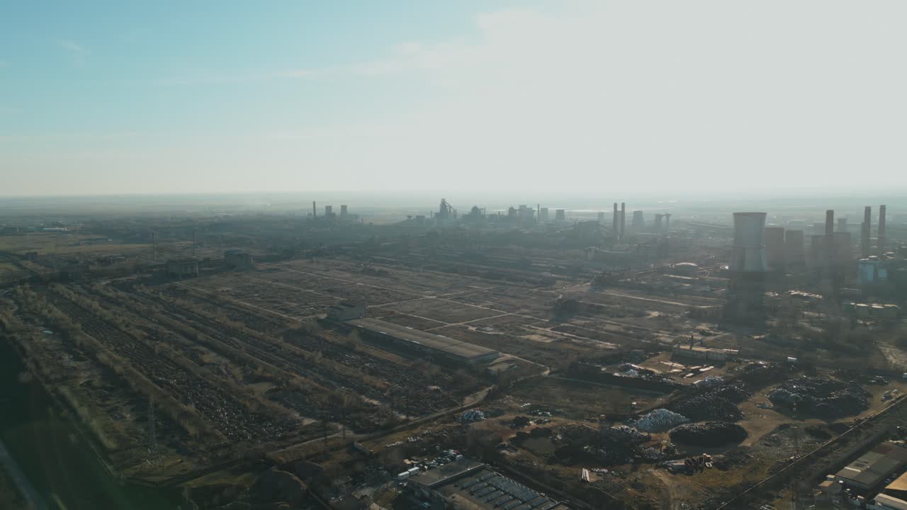 Aerial View Of Galati Steel Plant In Industrial Smog In Galati, Romania. wide pullback shot