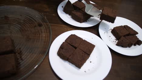 keto chocolate brownie cake being served on three white plates