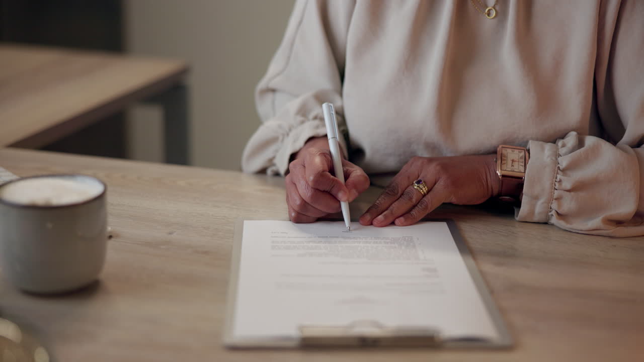 Businesswoman signing a contract at a desk