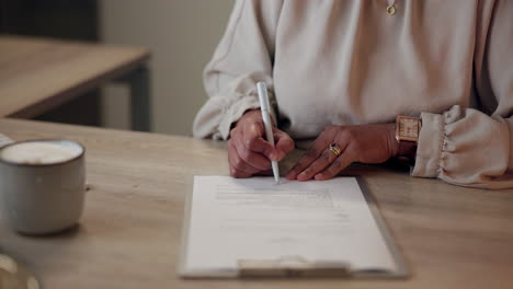 businesswoman signing a contract at a desk