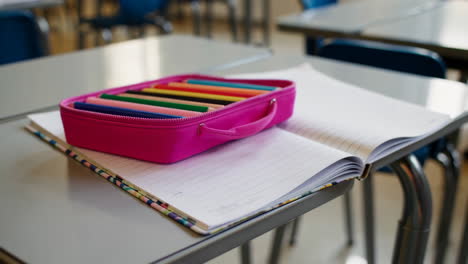 classroom desk with school supplies