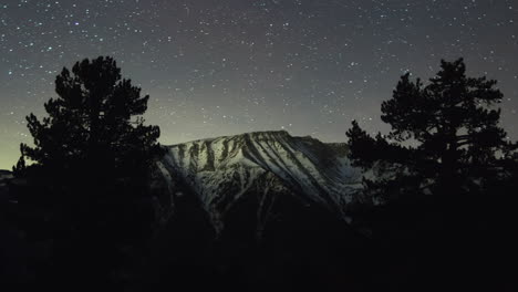 astro night timelapse mountain olympus snowy peaks pine forest trees tilt up