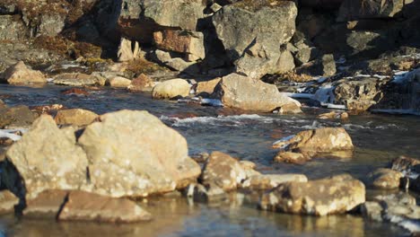 cold river rocks with clear water running