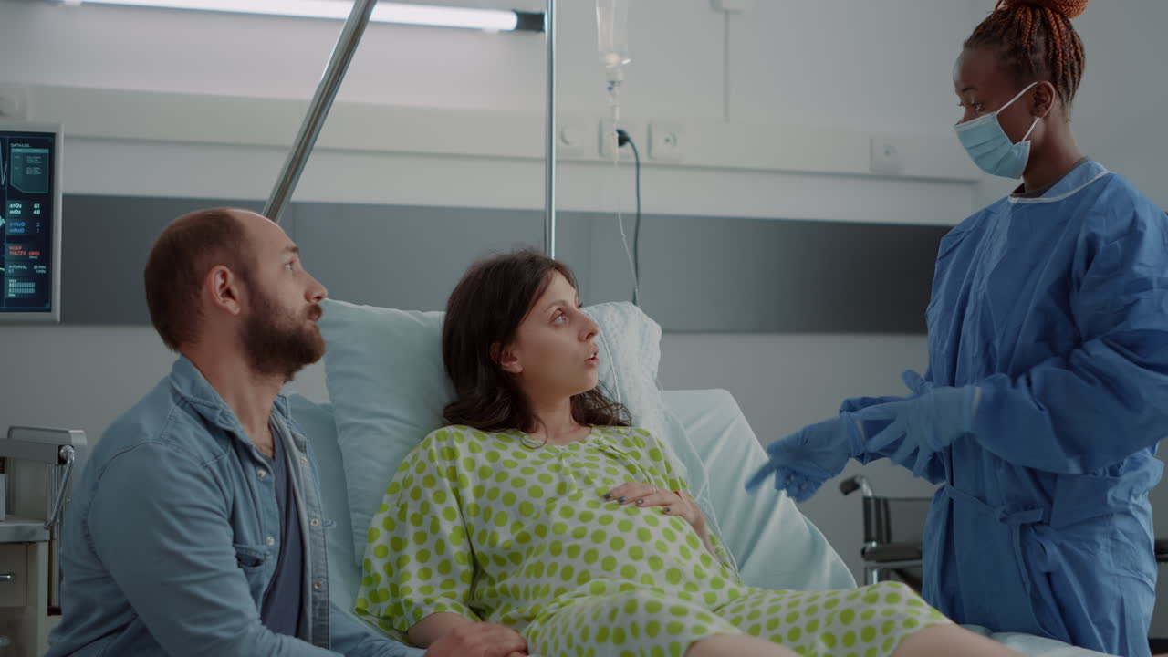 Caucasian family expecting baby in hospital ward