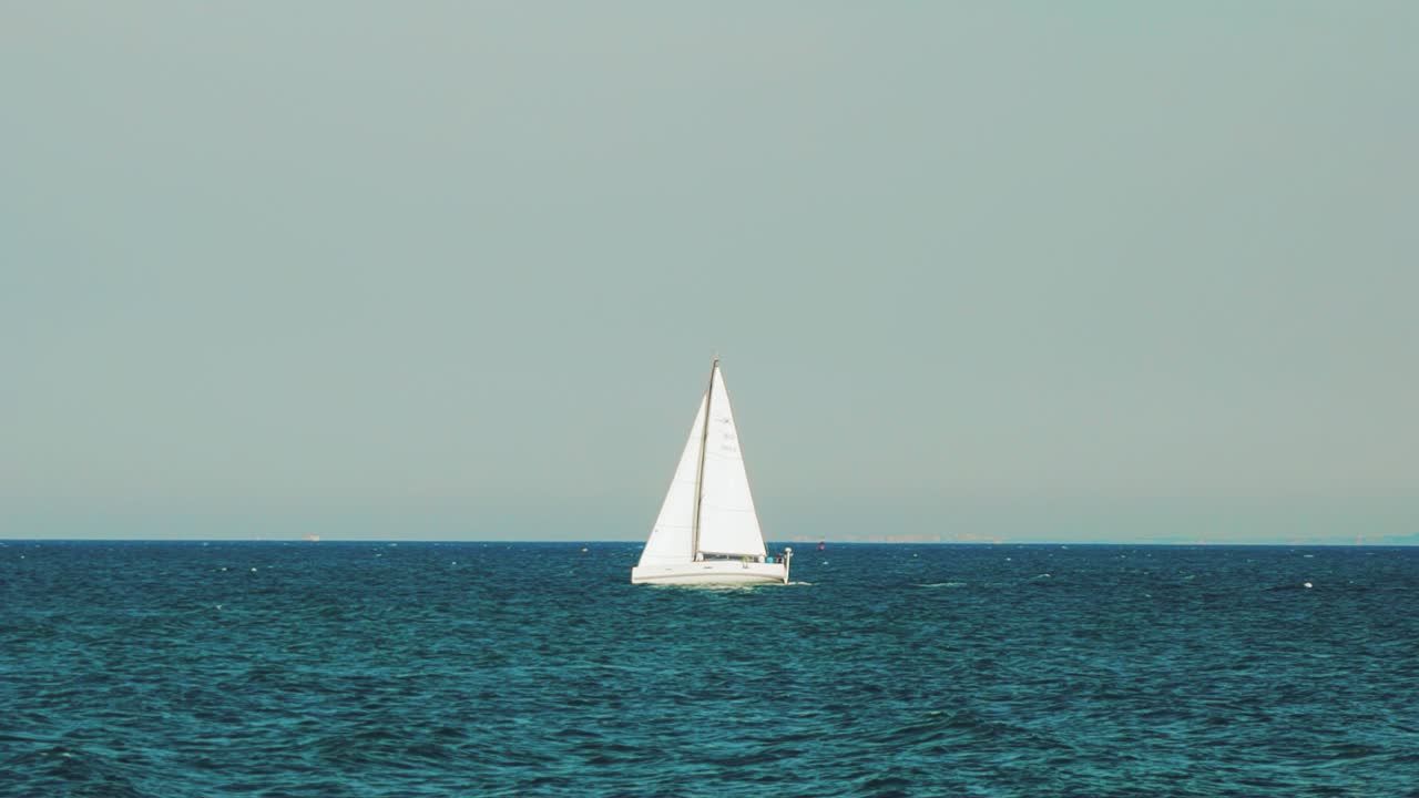 Sea with a sailboat on the horizon. Sea horizon.