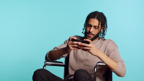 ecstatic gamer with disability winning game on phone, studio background