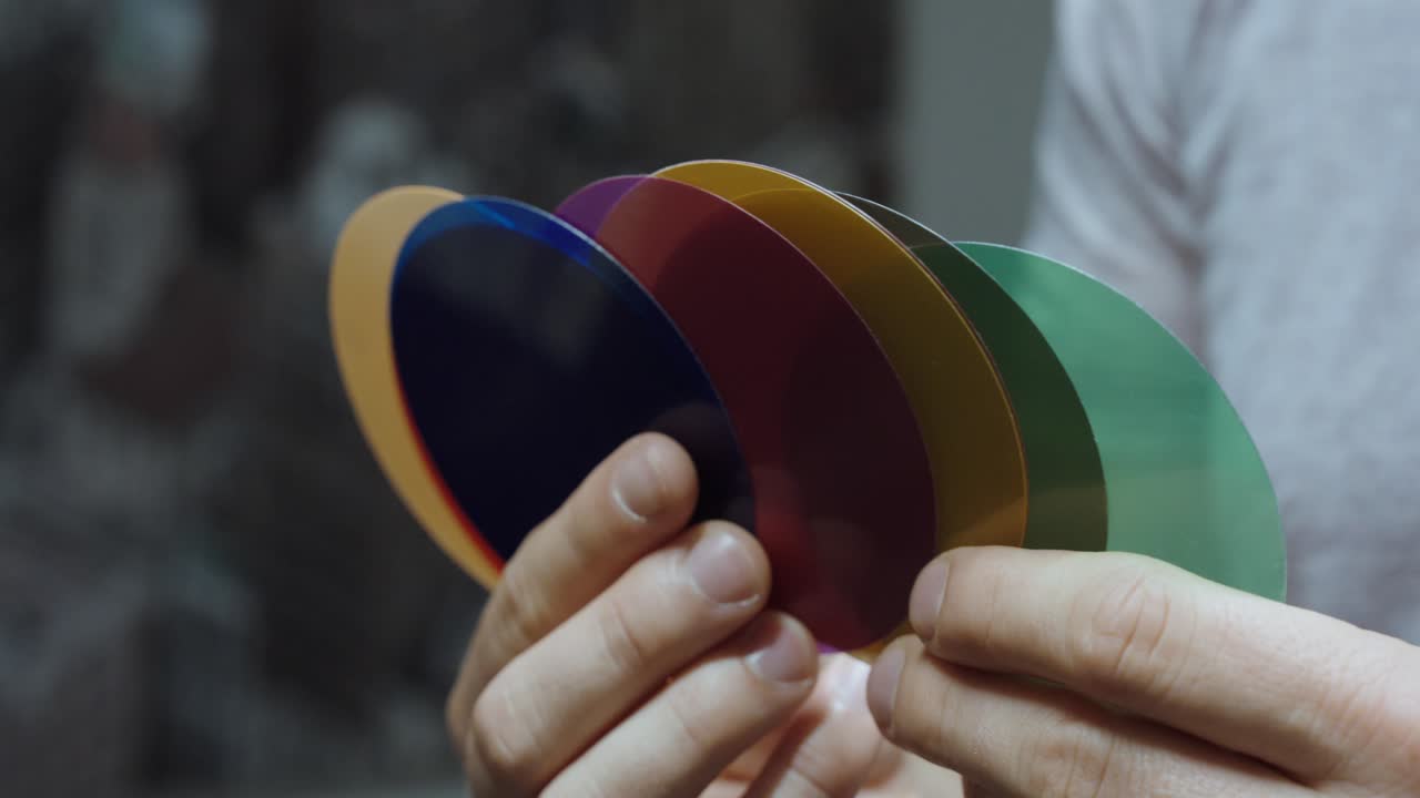 A person holding color samples for design or material selection, creative choice and palette concept