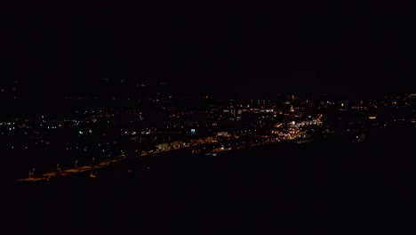 night timelapse of town with cars driving from above