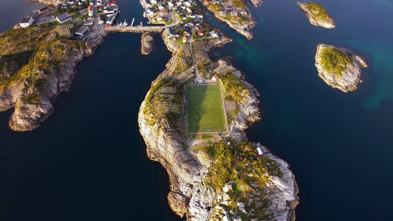 Coastal town Henningsvær with famous soccer field, seen from above at dramatic Lofoten islands. Drone aerial