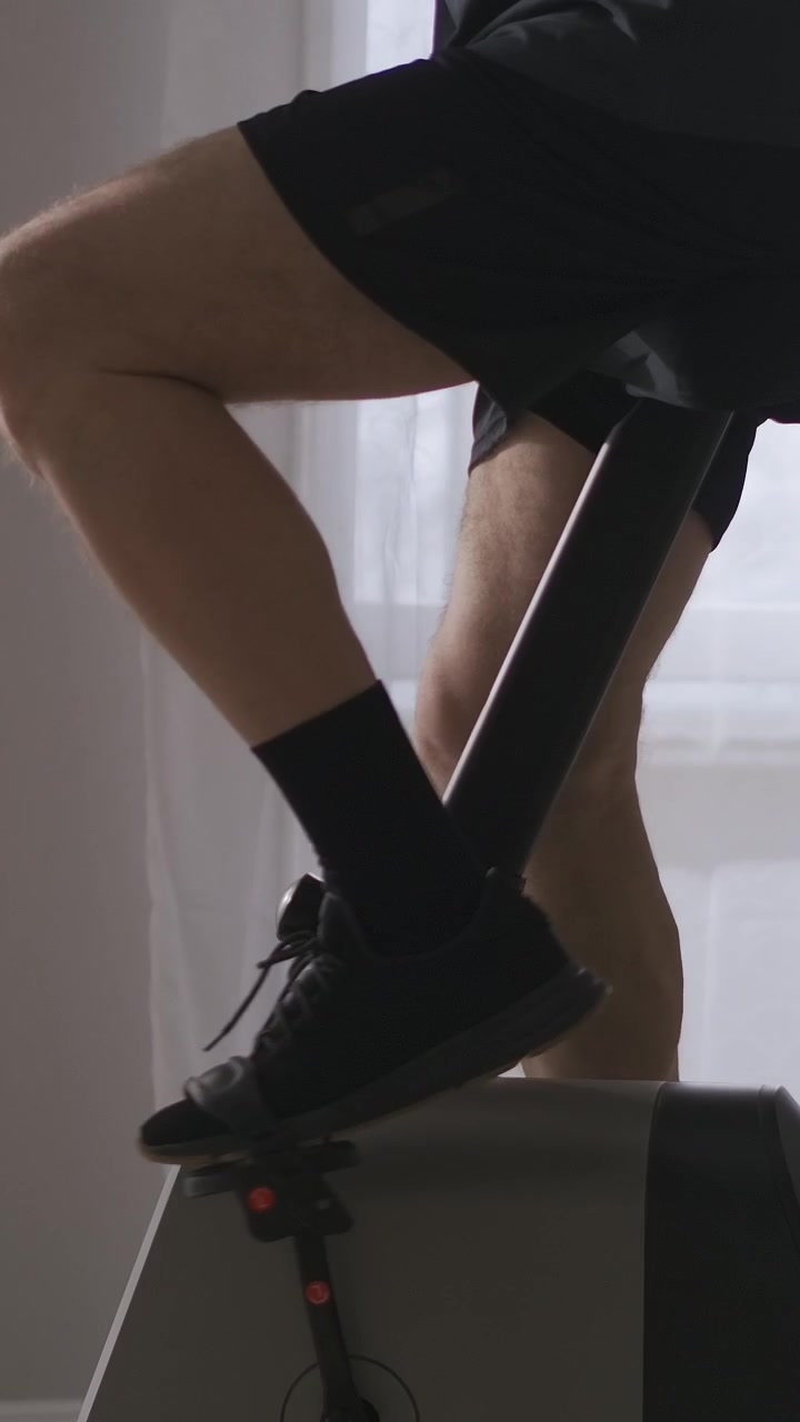 Senior Man Exercising on Elliptical Machine at Home