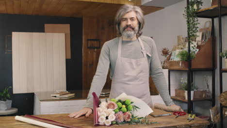 male florist with arranged bouquet of flowers