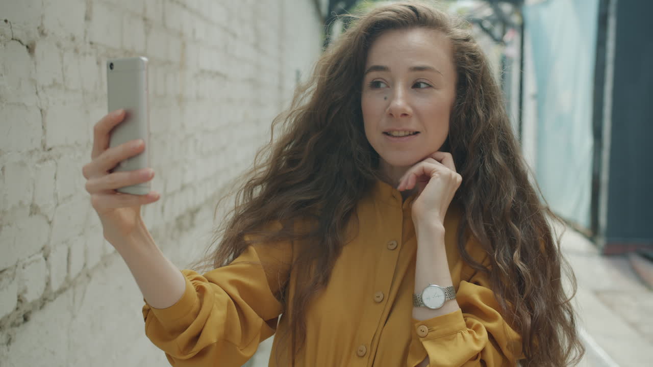Woman taking a selfie in an alley