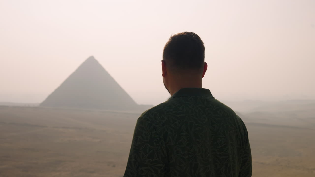 A Man Amazed On The Sights Of The Giza Pyramid Complex During Sunrise In Egypt. Rear, Closeup Shot