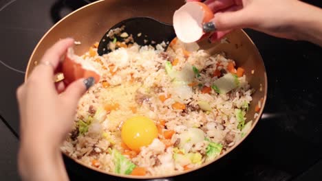 sequential egg cracking into a bowl of fried rice