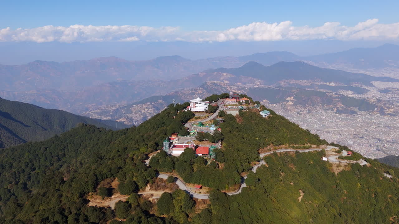 Aerial tracking shot in front of the Chandragiri hill, in sunny Kathmandu, Nepal