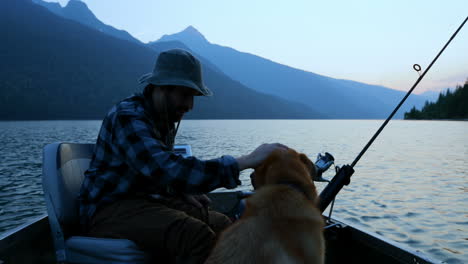 fisherman fishing with his dog in the river 4k