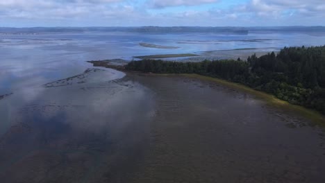 aerial reveal of small peninsula along the coast of washington state