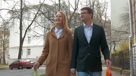 Elegant-man-and-woman-walking-after-shopping