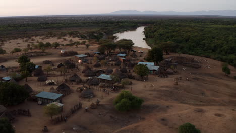 karo tribe with traditional african hut near omo river in ethiopia