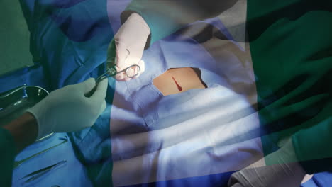 animación de la bandera de nigeria ondeando sobre los cirujanos en el quirófano