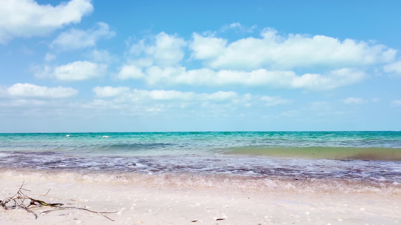 A beautiful view of the calm sea with gentle waves and clear skies at Holbox Punta Cocos, Mexico